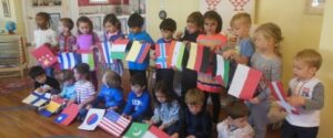 Children posing with the flags of different nations