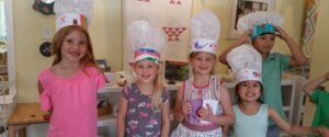 Children wearing colorful hats in an Open House event