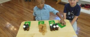 Two children are posing during the art class