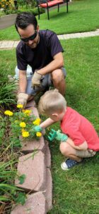 A young boy is being taught about gardening